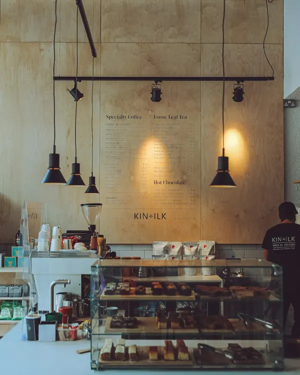Café owner serving a customer at the counter