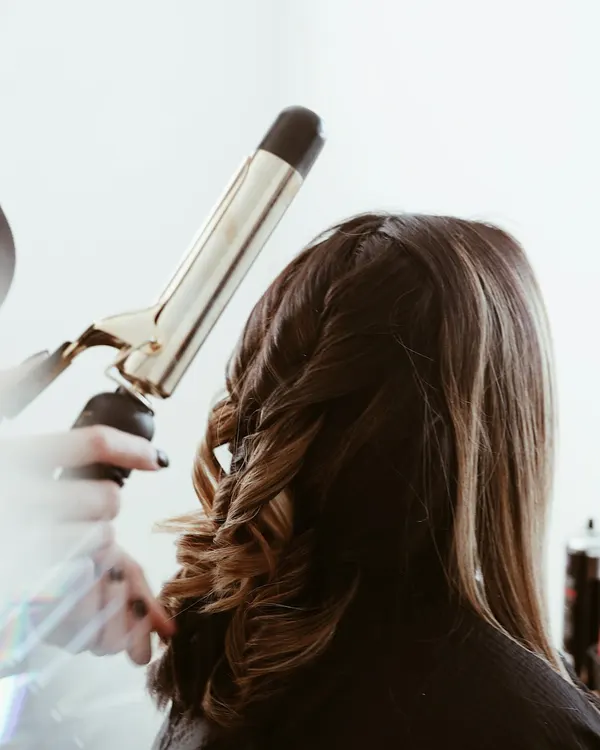 Hair stylist working with a client in a salon