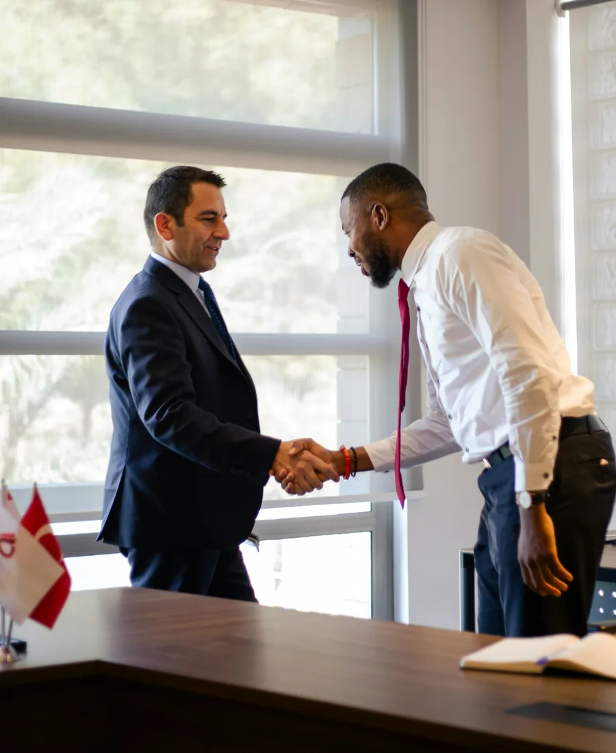 Two business owners shaking hands on a funding deal