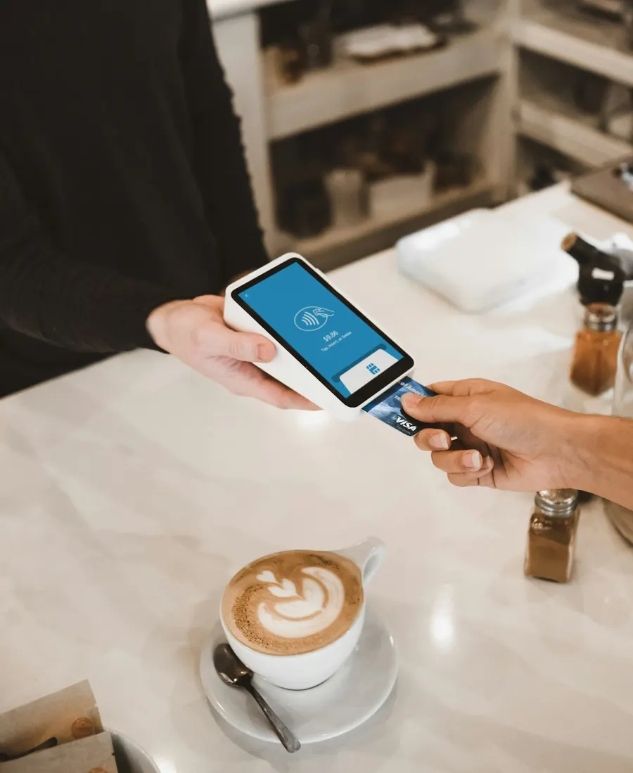 Customer paying by contactless card at a shop counter